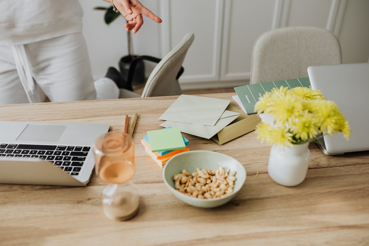 Laptop on desk with papers and peanuts